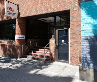 Entrance to the Inter-Cultural Association building with brick facade and stairs.